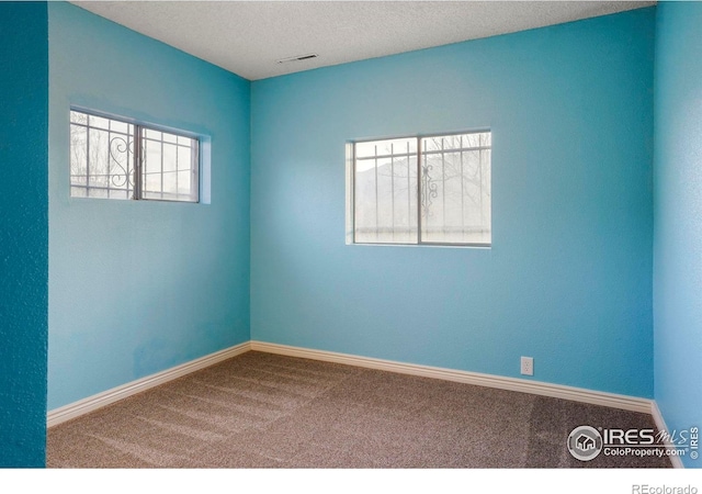 1458 Friendship Ln W, Colorado Springs, CO 80904 - carpeted empty room featuring visible vents, baseboards, and a textured ceiling