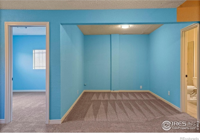 1458 Friendship Ln W, Colorado Springs, CO 80904 - carpeted empty room featuring a textured ceiling and baseboards
