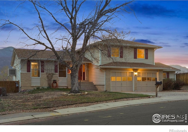 1458 Friendship Ln W, Colorado Springs, CO 80904 - tri-level home with a garage, brick siding, driveway, and fence