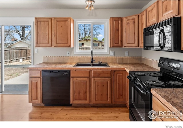 422 38th Ave, Greeley, CO 80634 - kitchen with plenty of natural light, a sink, black appliances, and light wood-type flooring
