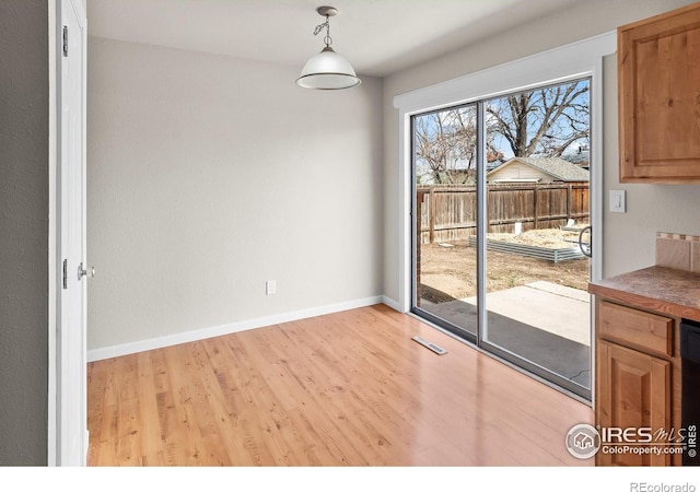 422 38th Ave, Greeley, CO 80634 - unfurnished dining area with baseboards, wood finished floors, and visible vents