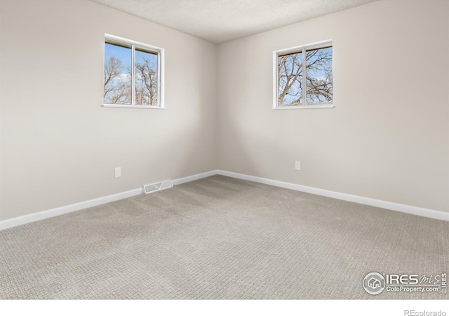 422 38th Ave, Greeley, CO 80634 - carpeted empty room with baseboards, plenty of natural light, and visible vents