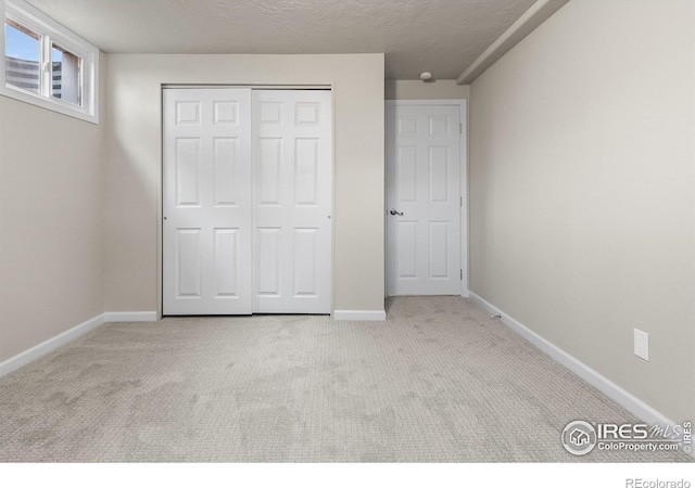 422 38th Ave, Greeley, CO 80634 - unfurnished bedroom with carpet flooring, a textured ceiling, baseboards, and a closet