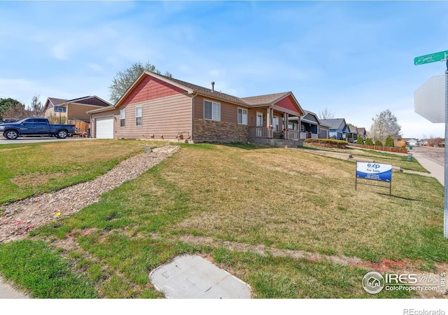 exterior space with an attached garage, covered porch, stone siding, and a front lawn
