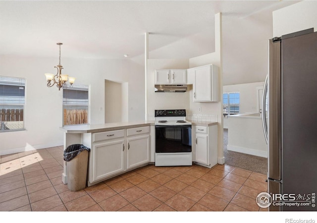 kitchen featuring a peninsula, freestanding refrigerator, white cabinets, range with electric cooktop, and lofted ceiling