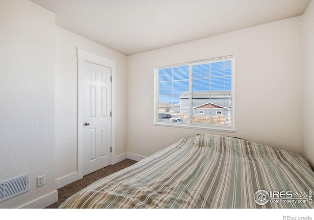 bedroom featuring visible vents, baseboards, and carpet flooring
