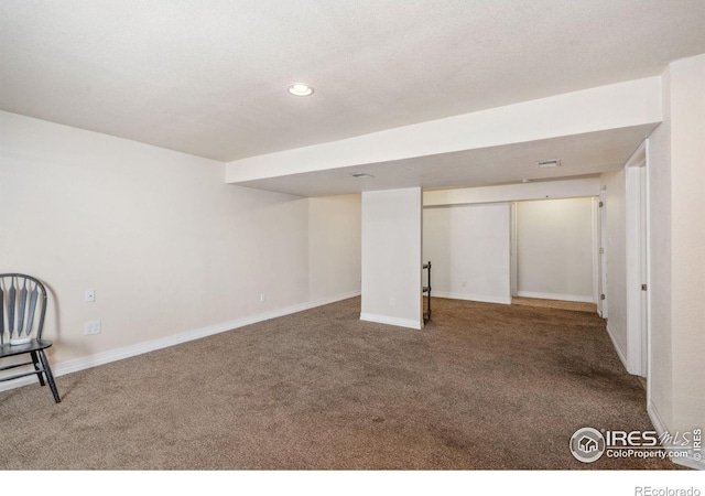 finished below grade area with carpet floors, baseboards, recessed lighting, and visible vents