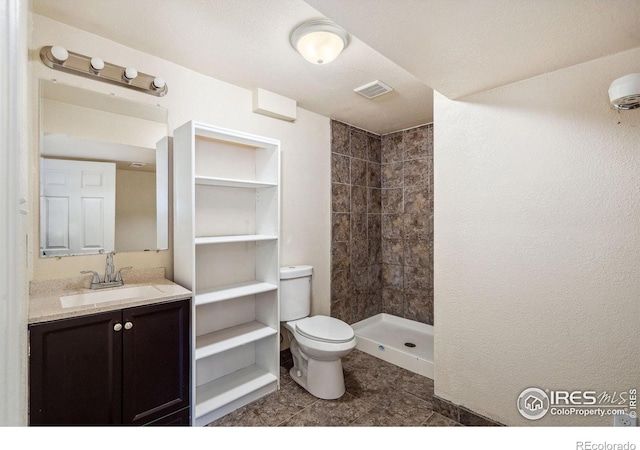 bathroom with vanity, tile patterned flooring, visible vents, toilet, and a stall shower