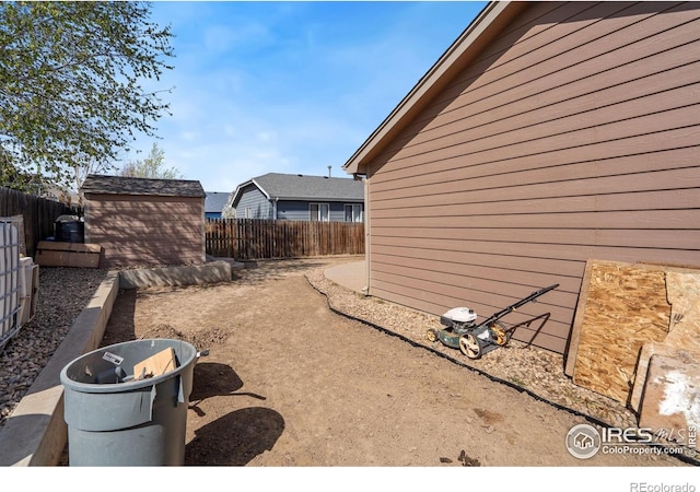 view of property exterior featuring an outbuilding and a fenced backyard