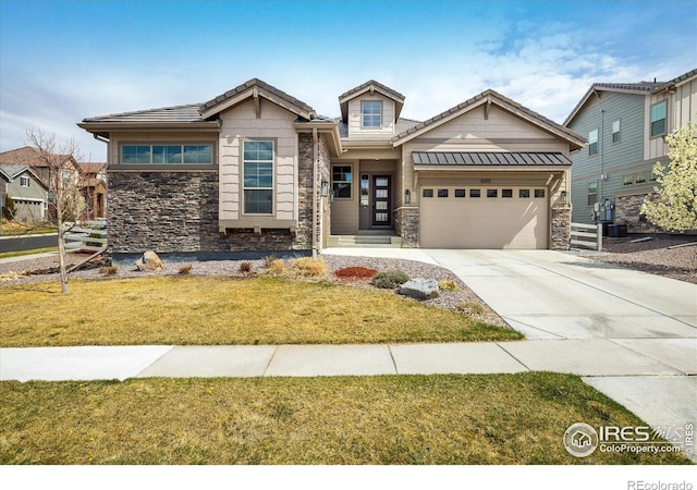 16392 Spanish Peak Way, Broomfield, CO 80023 - craftsman house featuring stone siding, an attached garage, driveway, a front lawn, and cooling unit