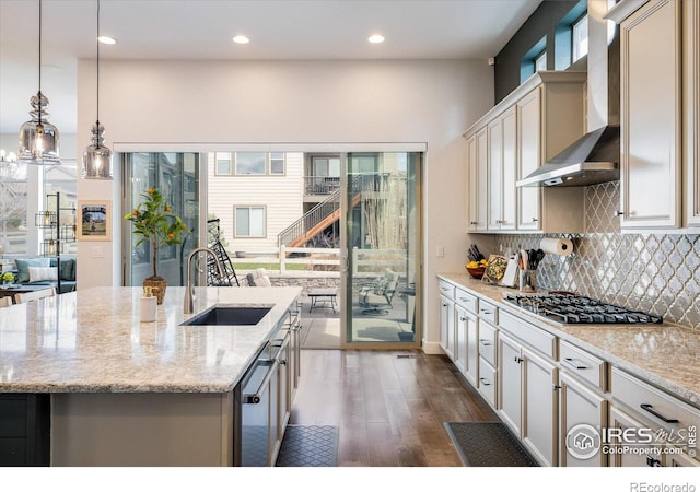 16392 Spanish Peak Way, Broomfield, CO 80023 - kitchen with a sink, stainless steel gas stovetop, wall chimney exhaust hood, dark wood finished floors, and backsplash