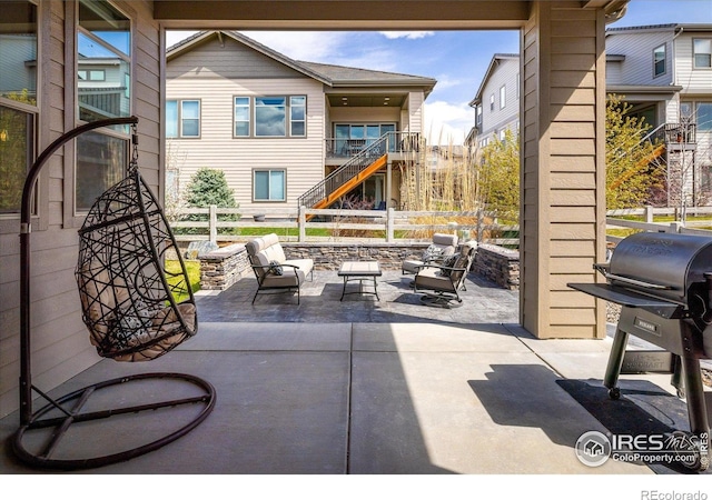 16392 Spanish Peak Way, Broomfield, CO 80023 - view of patio with fence, area for grilling, stairway, and outdoor lounge area
