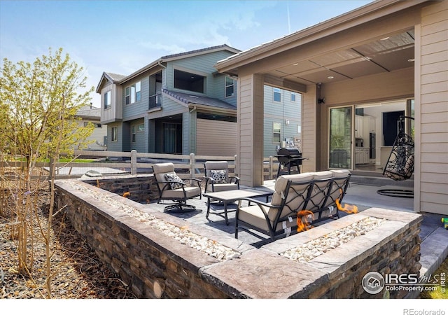 16392 Spanish Peak Way, Broomfield, CO 80023 - view of patio featuring fence, an outdoor living space with a fire pit, and grilling area