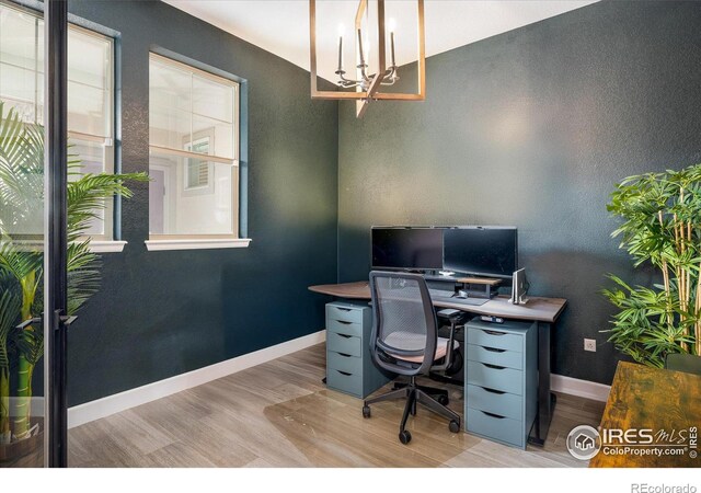 16392 Spanish Peak Way, Broomfield, CO 80023 - home office with wood finished floors, a chandelier, baseboards, and a textured wall