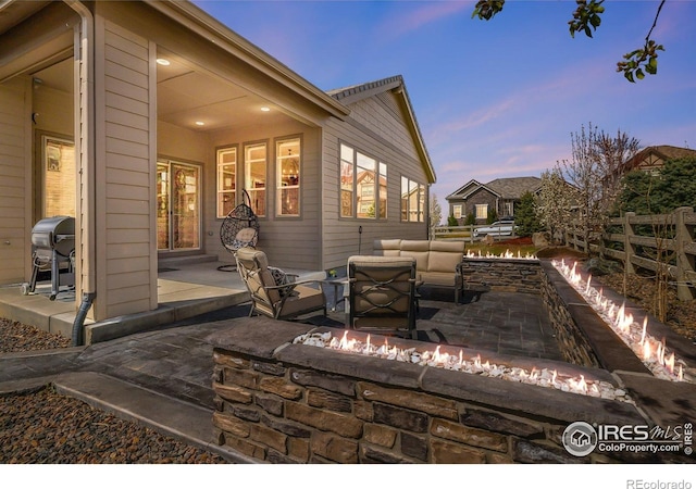 16392 Spanish Peak Way, Broomfield, CO 80023 - view of patio / terrace featuring an outdoor living space with a fire pit, fence, and grilling area