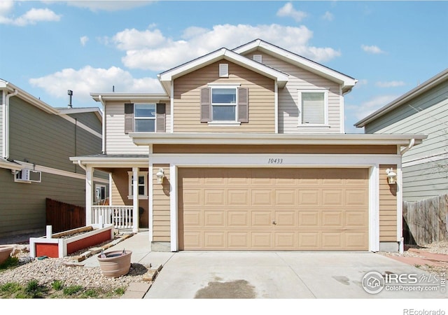 10433 Forester Pl, Longmont, CO 80504 - traditional home featuring concrete driveway, a porch, and a garage
