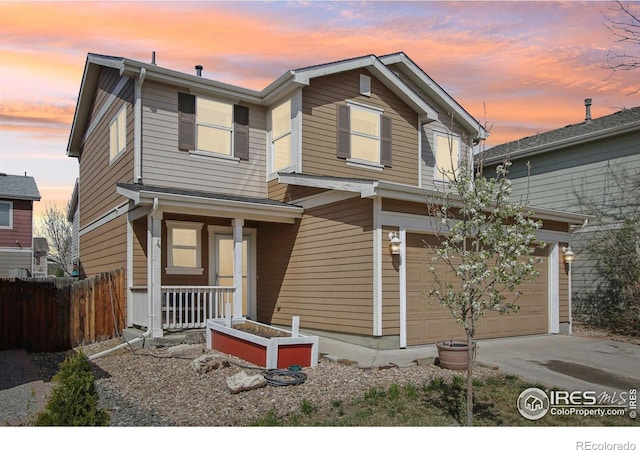 10433 Forester Pl, Longmont, CO 80504 - view of front of house with a porch, fence, a garage, and driveway