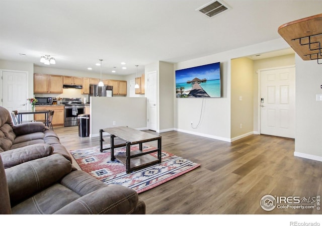 10433 Forester Pl, Longmont, CO 80504 - living room featuring recessed lighting, baseboards, visible vents, and wood finished floors