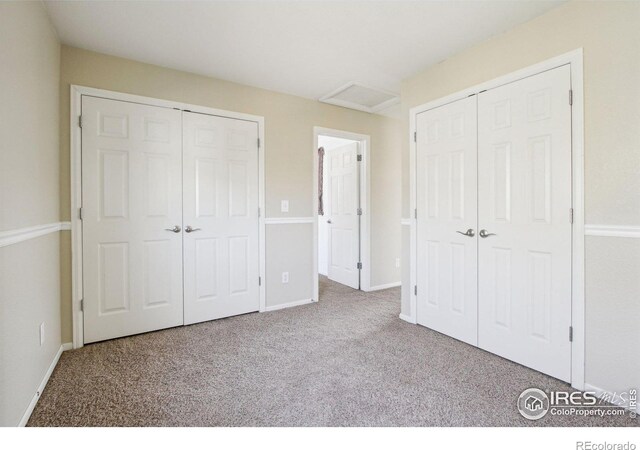 10433 Forester Pl, Longmont, CO 80504 - unfurnished bedroom featuring attic access, baseboards, and carpet floors