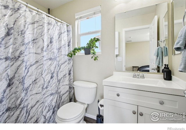 10433 Forester Pl, Longmont, CO 80504 - bathroom featuring toilet, a shower with curtain, and vanity