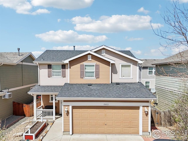 10433 Forester Pl, Longmont, CO 80504 - view of front facade with concrete driveway, roof with shingles, fence, and a garage