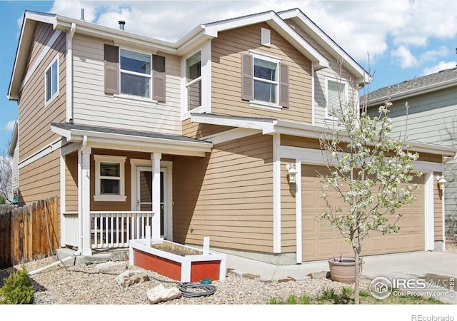 10433 Forester Pl, Longmont, CO 80504 - view of front facade with a porch, fence, an attached garage, and driveway