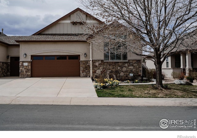 6771 Crooked Stick Dr, Windsor, CO 80550 - view of front facade featuring stone siding, an attached garage, driveway, roof with shingles, and stucco siding