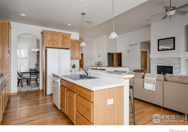 6771 Crooked Stick Dr, Windsor, CO 80550 - kitchen with a sink, dishwasher, open floor plan, a breakfast bar area, and light wood-style floors