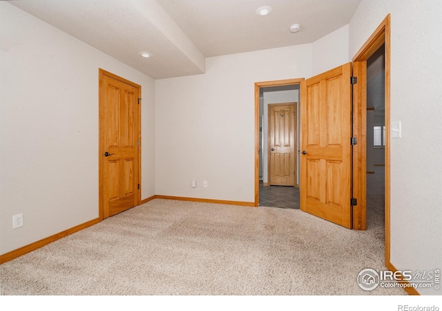6771 Crooked Stick Dr, Windsor, CO 80550 - empty room featuring carpet, baseboards, and a smoke detector