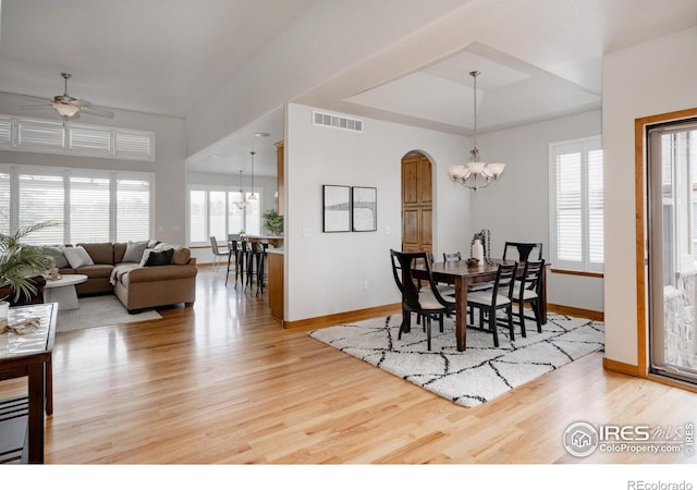 6771 Crooked Stick Dr, Windsor, CO 80550 - dining room with a chandelier, ceiling fan, light wood finished floors, baseboards, and arched walkways
