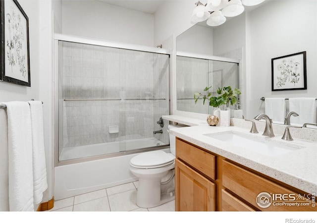 6771 Crooked Stick Dr, Windsor, CO 80550 - bathroom with tile patterned floors, toilet, vanity, bath / shower combo with glass door, and a chandelier