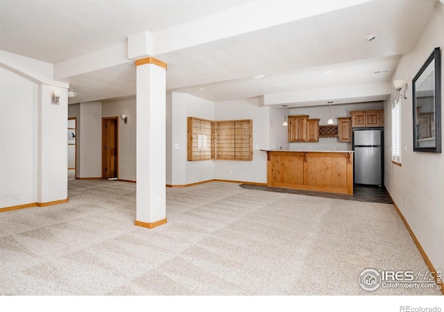 6771 Crooked Stick Dr, Windsor, CO 80550 - unfurnished living room with baseboards, light colored carpet, and decorative columns