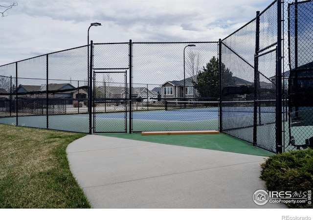 6771 Crooked Stick Dr, Windsor, CO 80550 - view of tennis court with a gate and fence