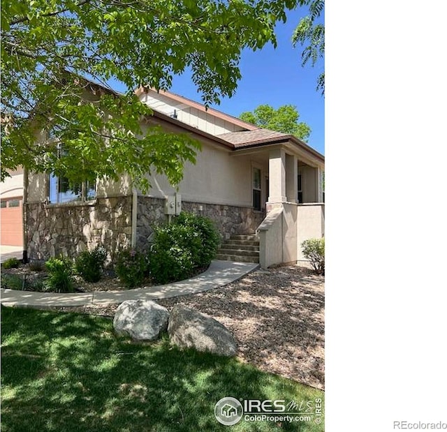 6771 Crooked Stick Dr, Windsor, CO 80550 - view of home's exterior featuring stone siding
