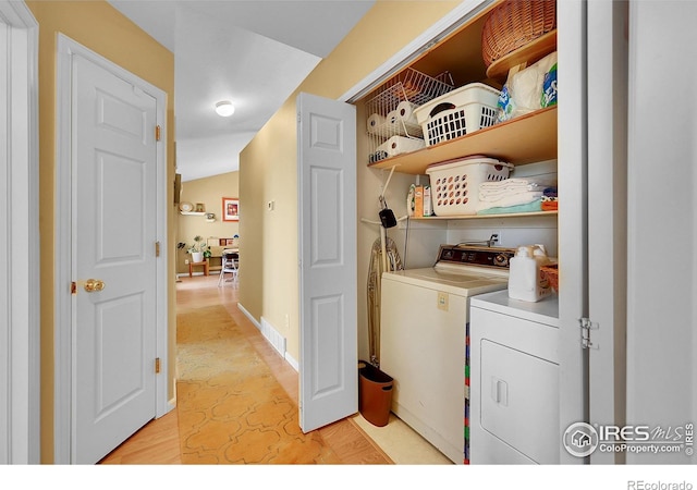 clothes washing area with washer and dryer, laundry area, visible vents, and light floors
