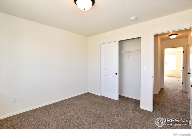 8606 8th St, Greeley, CO 80634 - unfurnished bedroom with a closet, dark colored carpet, and baseboards
