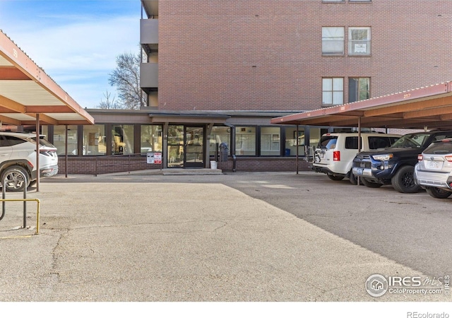 view of building exterior with covered parking