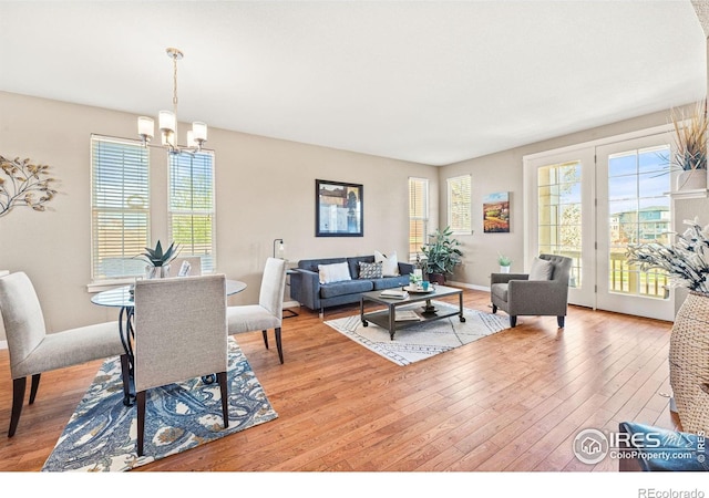 658 Casper Dr, Lafayette, CO 80026 - dining space featuring a chandelier, healthy amount of natural light, wood-type flooring, and baseboards