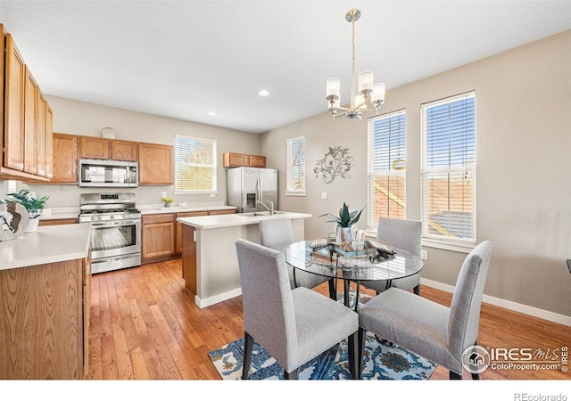 658 Casper Dr, Lafayette, CO 80026 - dining room featuring a chandelier, light wood-style flooring, recessed lighting, and baseboards