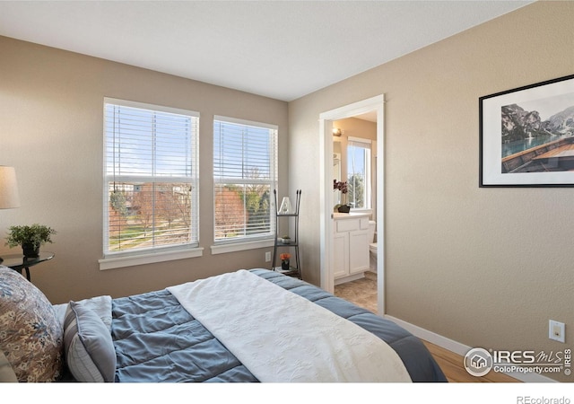 658 Casper Dr, Lafayette, CO 80026 - bedroom featuring baseboards and ensuite bath