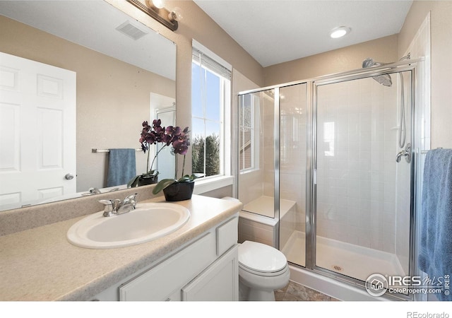 658 Casper Dr, Lafayette, CO 80026 - bathroom with a stall shower, vanity, toilet, and tile patterned flooring