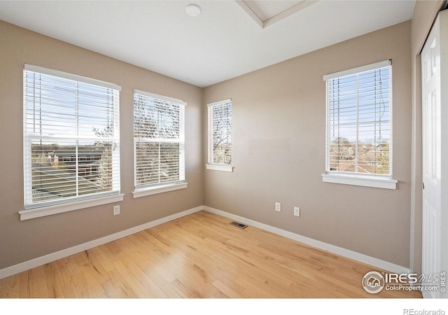 658 Casper Dr, Lafayette, CO 80026 - unfurnished room featuring baseboards, wood finished floors, and attic access