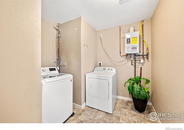 658 Casper Dr, Lafayette, CO 80026 - laundry room with water heater, washing machine and dryer, and baseboards