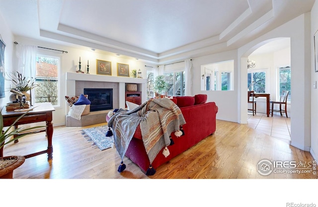 5105 Nelson Ct, Fort Collins, CO 80528 - living room featuring arched walkways, plenty of natural light, and a raised ceiling