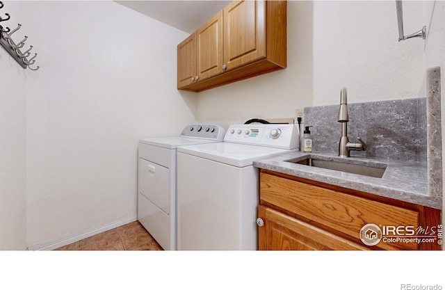 5105 Nelson Ct, Fort Collins, CO 80528 - washroom with separate washer and dryer, baseboards, light tile patterned floors, cabinet space, and a sink