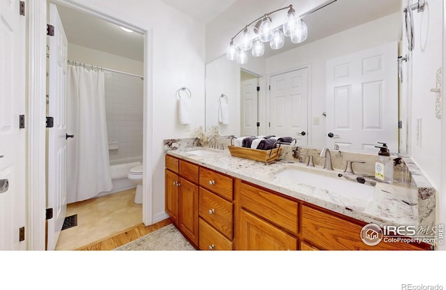 5105 Nelson Ct, Fort Collins, CO 80528 - bathroom with double vanity, shower / bathtub combination with curtain, a sink, and toilet