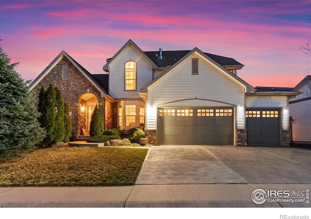 7225 Royal Country Down Dr, Windsor, CO 80550 - traditional-style house featuring stone siding, an attached garage, and concrete driveway