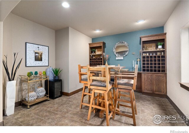 7225 Royal Country Down Dr, Windsor, CO 80550 - tiled dining space featuring recessed lighting, arched walkways, and baseboards