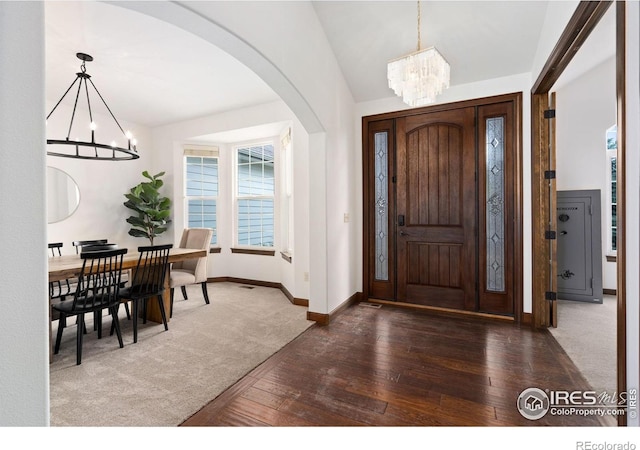 7225 Royal Country Down Dr, Windsor, CO 80550 - foyer entrance featuring a chandelier, hardwood / wood-style flooring, arched walkways, and baseboards