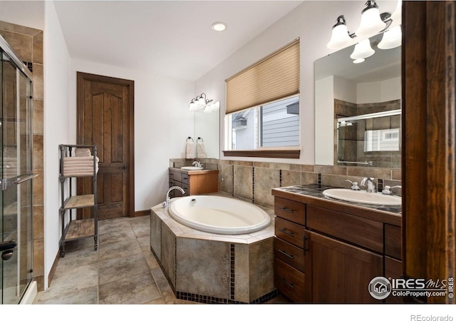 7225 Royal Country Down Dr, Windsor, CO 80550 - full bathroom with a shower stall, two vanities, a bath, a chandelier, and tile patterned flooring